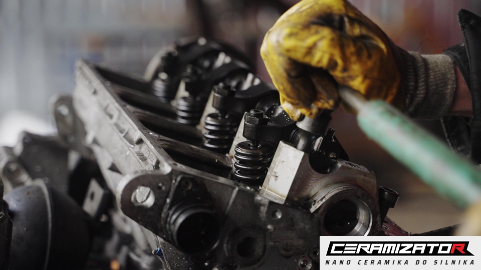 A technician working on a cylinder head and valvetrain