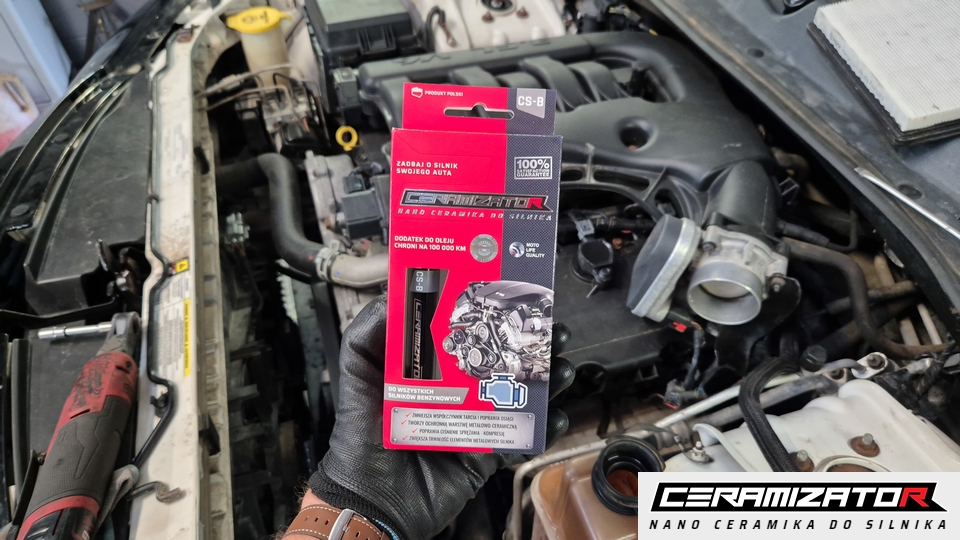 A Cerator CS-B package held in front of an open engine bay